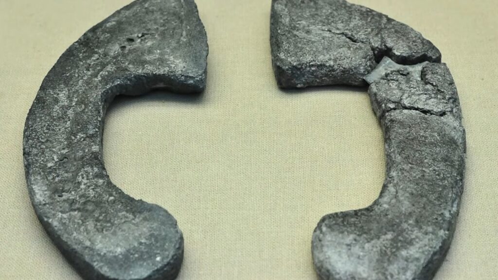 Two ancient Greek stone halteres used by athletes for long jumps.