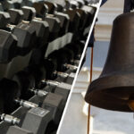 Dumbbells on a gym rack beside a large hanging bell.
